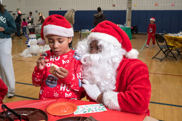 santa clause and child working on crafts
